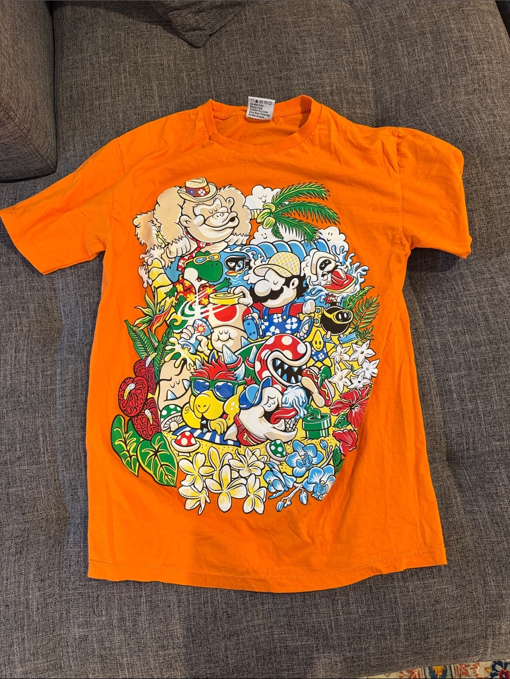 Orange Mens Graphic Tee with Tropical Game Characters